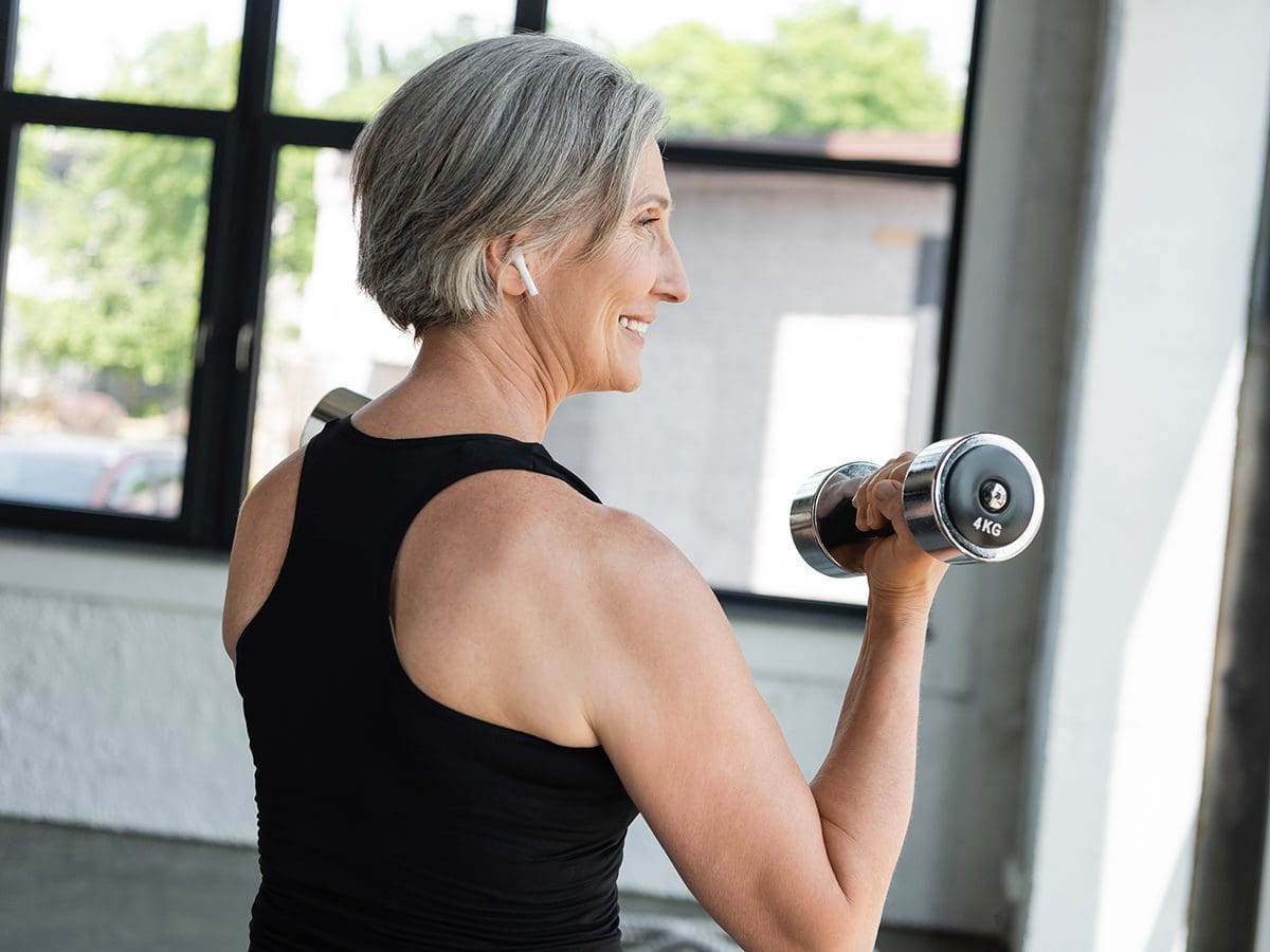 Middle-aged woman lifting small hand-held weight