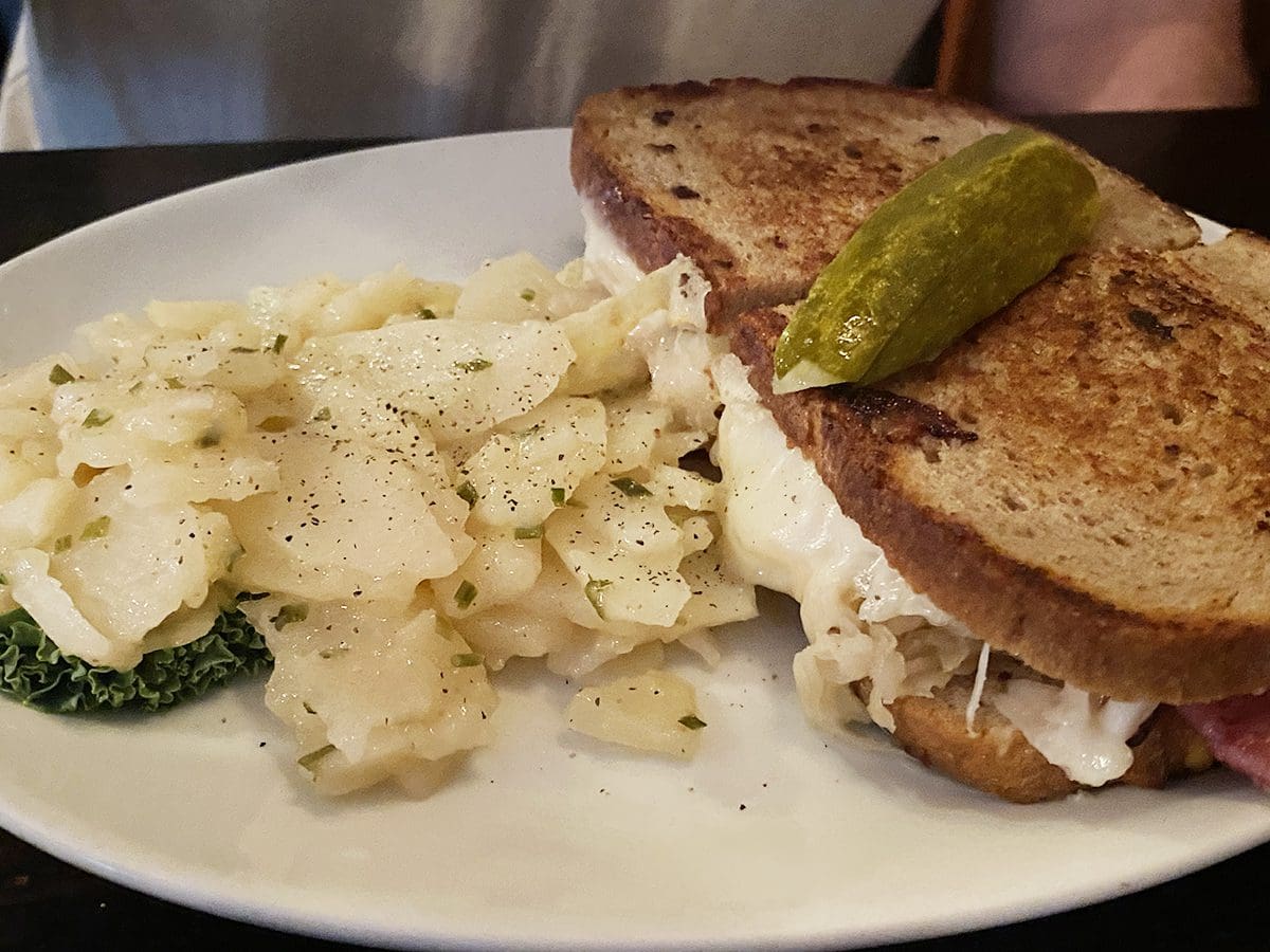 Alpine Inn's reuben sandwich and German potato salad served to customer