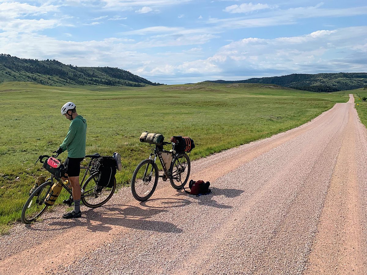 Man bikepacking along gravel road in the Black Hills