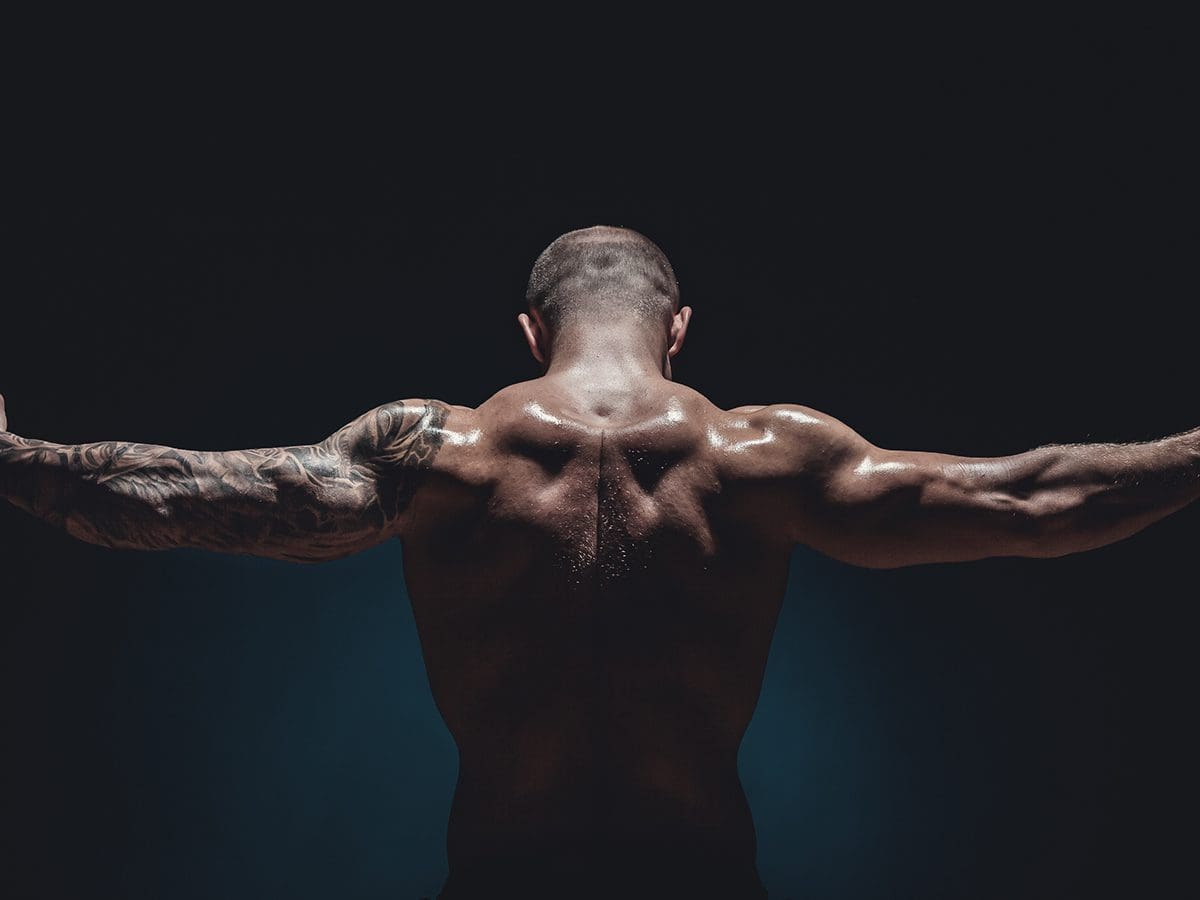 strong, muscular man showing off back and shoulder muscles