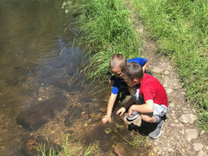grace coolidge trail boys playing in water 300x225