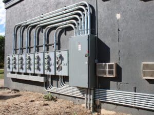 whites electrical conduit and breaker boxes outside 300x225