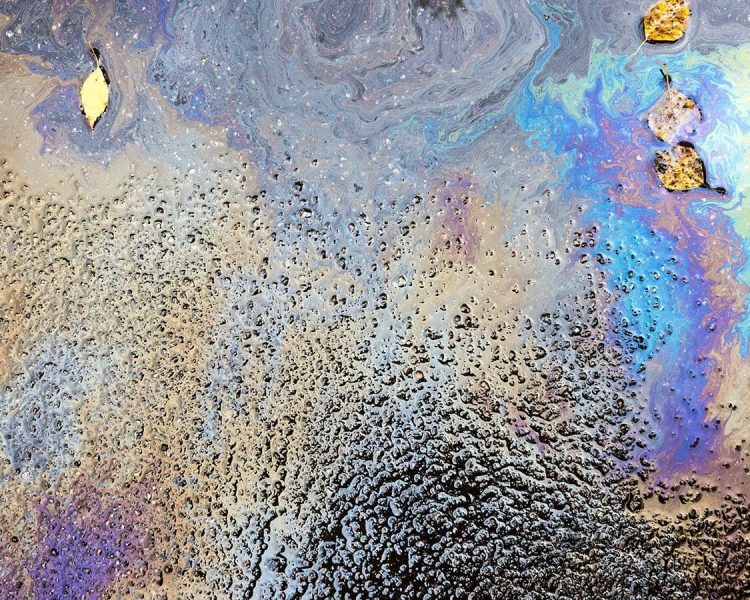 Oil and debris on wet asphalt