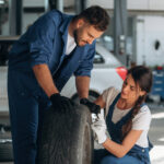 Car mechanics inspecting tire