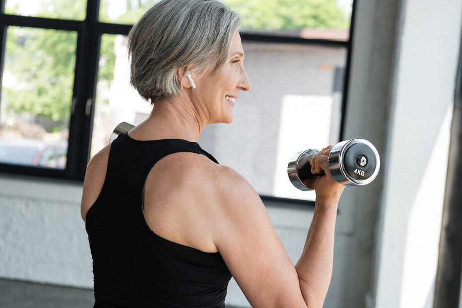 Middle-aged woman lifting small hand-held weight