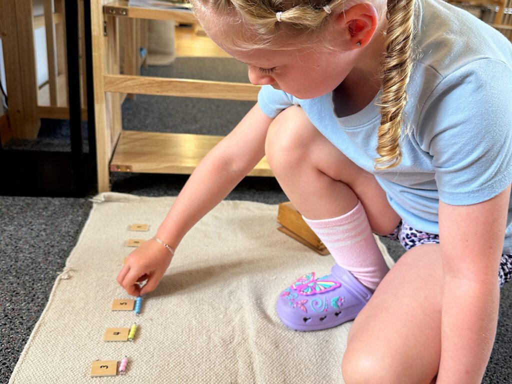 girl doing hands-on lesson at rapid city Montessori
