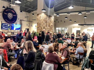 hairy cow brewing company indoors filled with patrons 300x225