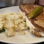 Alpine Inn's reuben sandwich and German potato salad served to customer