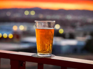 valley taphouse beer on rail with sunset 300x225